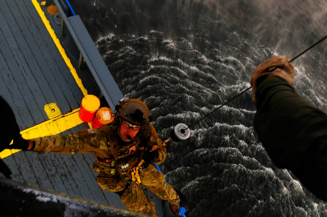 An Air Force special operations pararescueman gets hoisted off a ship by Navy Petty Officer 2nd Class Kurt Leisenring during the Emerald Warrior 2013 exercise off Florida’s Gulf Coast, April 24, 2013. U.S. Special Operations Command’s Preservation of the Force and Family Task Force is implementing a holistic program to promote operators’ physical, psychological, spiritual and social performance to support mission readiness. U.S. Air Force photo by Tech. Sgt. Quinton Russ
