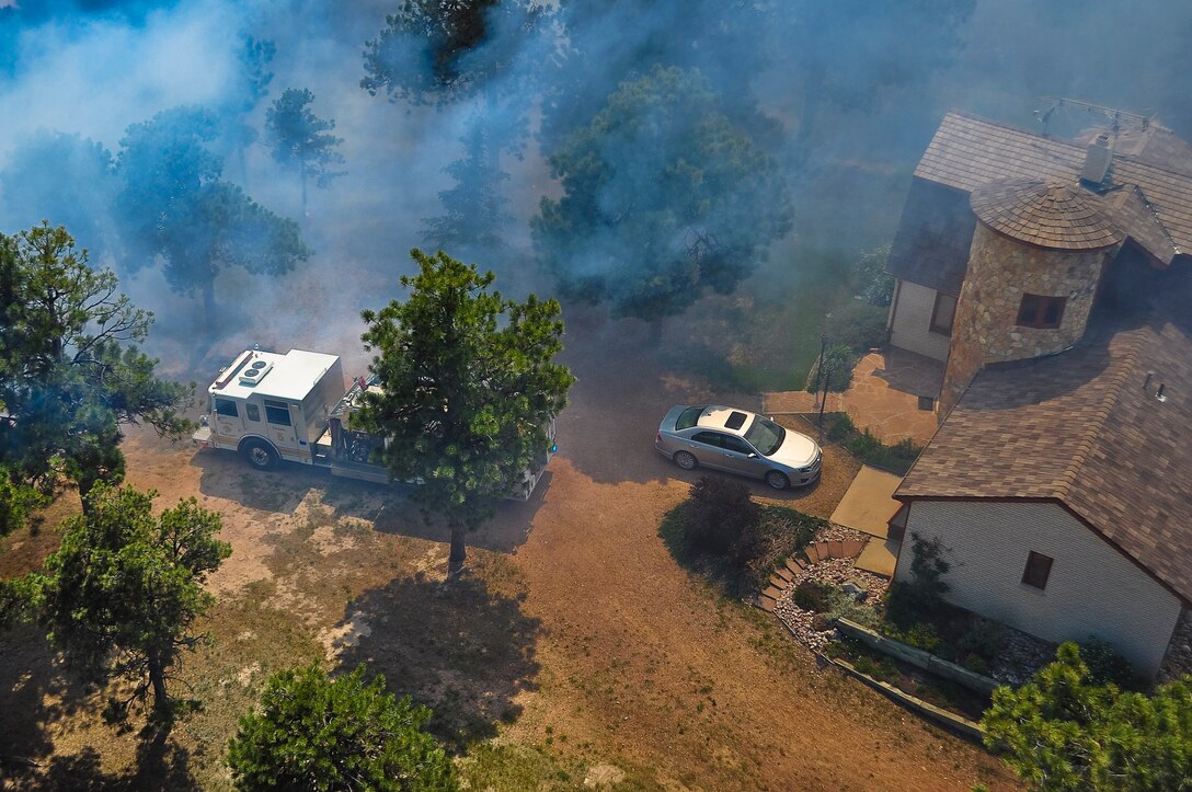 Colorado National Guard members get an aerial view of the fire damage from a Black Hawk helicopter while performing drops on the Black Forest fire in Colorado Springs, Colo., June 12, 2013.
