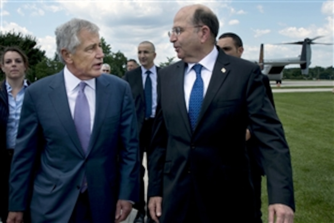 U.S. Defense Secretary Chuck Hagel greets Israeli Minister of Defense Moshe Ya'alon, who arrived at the Pentagon after taking a tour of the Washington, D.C., area in an MV-22 Osprey helicopter, June 14, 2013. 


