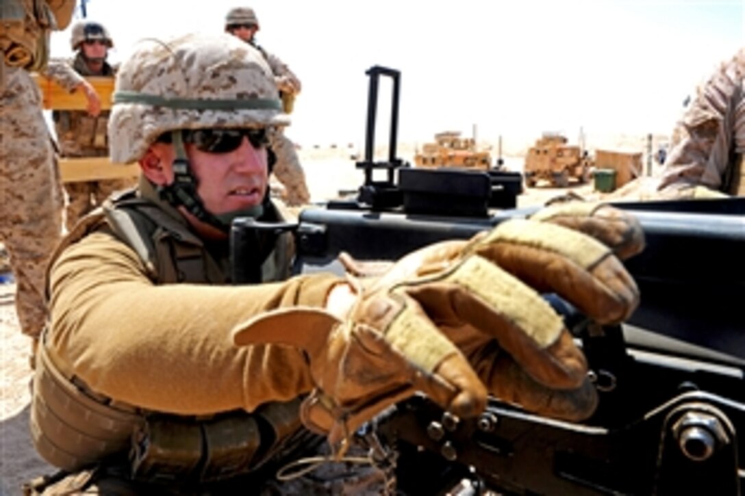 U.S. Navy Seaman Jeffrey Dimon, front, prepares an MK19 40mm grenade launcher while participating in marksmanship training on Camp Leatherneck, Helmand province, Afghanistan, June 1, 2013. Dimon, a construction mechanic, is assigned to Naval Mobile Construction Battalion 15's convoy security element. 