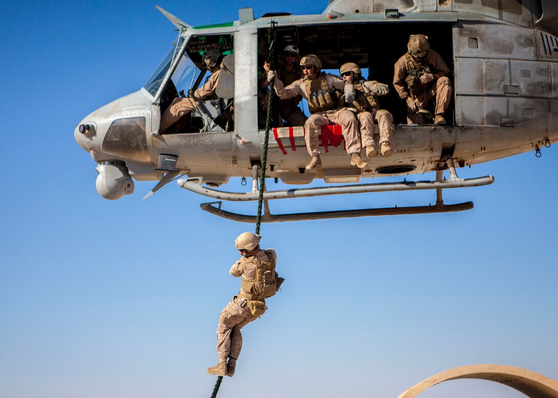 A 26th Marine Expeditionary Unit (MEU) Maritime Raid Force Marine fast ropes from a UH-1N Huey assigned to Marine Medium Tiltrotor Squadron (VMM) 266 (Reinforced), during a helicopter rope suspension technique exercise at King Faisal Air Base in Jordan, June 11, 2013. Exercise Eager Lion 2013 is an annual, multinational exercise designed to strengthen military-to-military relationships and enhance security and stability in the region by responding to modern-day security scenarios. The 26th MEU is a Marine Air-Ground Task Force forward-deployed to the U.S. 5th Fleet area of responsibility aboard the Kearsarge Amphibious Ready Group serving as a sea-based, expeditionary crisis response force capable of conducting amphibious operations across the full range of military operations. (U.S. Marine Corps photograph by Sgt. Christopher Q. Stone, 26th MEU Combat Camera/Released)