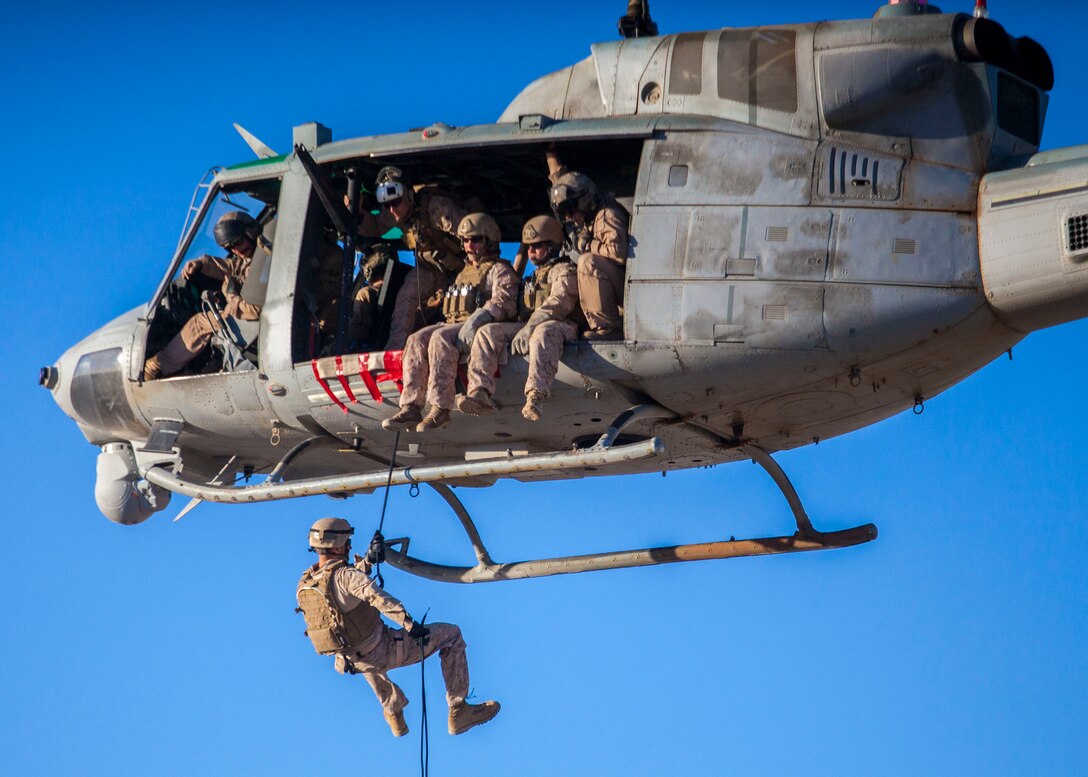 A 26th Marine Expeditionary Unit (MEU) Maritime Raid Force Marine rappels from a UH-1N Huey assigned to Marine Medium Tiltrotor Squadron (VMM) 266 (Reinforced), during a helicopter rope suspension technique exercise at King Faisal Air Base in Jordan, June 11, 2013. Exercise Eager Lion 2013 is an annual, multinational exercise designed to strengthen military-to-military relationships and enhance security and stability in the region by responding to modern-day security scenarios. The 26th MEU is a Marine Air-Ground Task Force forward-deployed to the U.S. 5th Fleet area of responsibility aboard the Kearsarge Amphibious Ready Group serving as a sea-based, expeditionary crisis response force capable of conducting amphibious operations across the full range of military operations. (U.S. Marine Corps photograph by Sgt. Christopher Q. Stone, 26th MEU Combat Camera/Released)