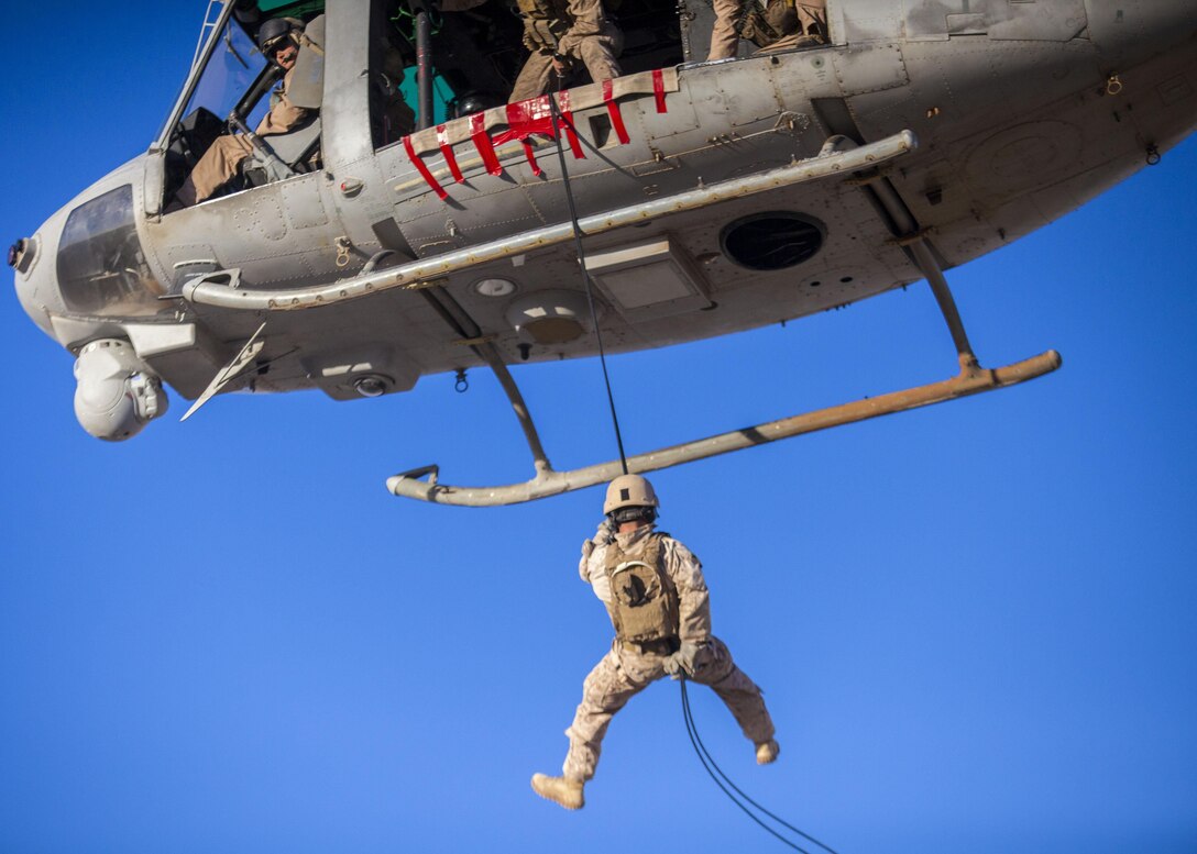A 26th Marine Expeditionary Unit (MEU) Maritime Raid Force Marine rappels from a UH-1N Huey assigned to Marine Medium Tiltrotor Squadron (VMM) 266 (Reinforced), during a helicopter rope suspension technique exercise at King Faisal Air Base in Jordan, June 11, 2013. Exercise Eager Lion 2013 is an annual, multinational exercise designed to strengthen military-to-military relationships and enhance security and stability in the region by responding to modern-day security scenarios. The 26th MEU is a Marine Air-Ground Task Force forward-deployed to the U.S. 5th Fleet area of responsibility aboard the Kearsarge Amphibious Ready Group serving as a sea-based, expeditionary crisis response force capable of conducting amphibious operations across the full range of military operations. (U.S. Marine Corps photograph by Sgt. Christopher Q. Stone, 26th MEU Combat Camera/Released)