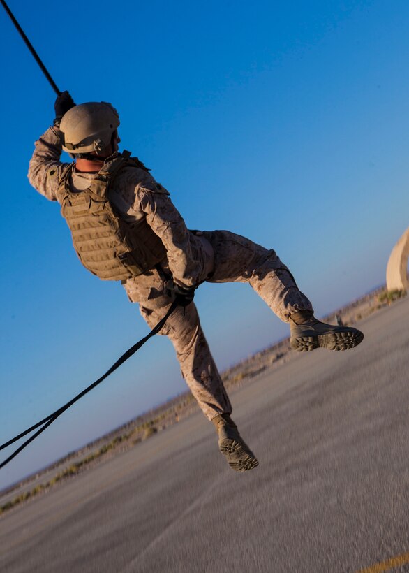 A 26th Marine Expeditionary Unit (MEU) Maritime Raid Force Marine rappels from a UH-1N Huey assigned to Marine Medium Tiltrotor Squadron (VMM) 266 (Reinforced), during a helicopter rope suspension technique exercise at King Faisal Air Base in Jordan, June 11, 2013. Exercise Eager Lion 2013 is an annual, multinational exercise designed to strengthen military-to-military relationships and enhance security and stability in the region by responding to modern-day security scenarios. The 26th MEU is a Marine Air-Ground Task Force forward-deployed to the U.S. 5th Fleet area of responsibility aboard the Kearsarge Amphibious Ready Group serving as a sea-based, expeditionary crisis response force capable of conducting amphibious operations across the full range of military operations. (U.S. Marine Corps photograph by Sgt. Christopher Q. Stone, 26th MEU Combat Camera/Released)
