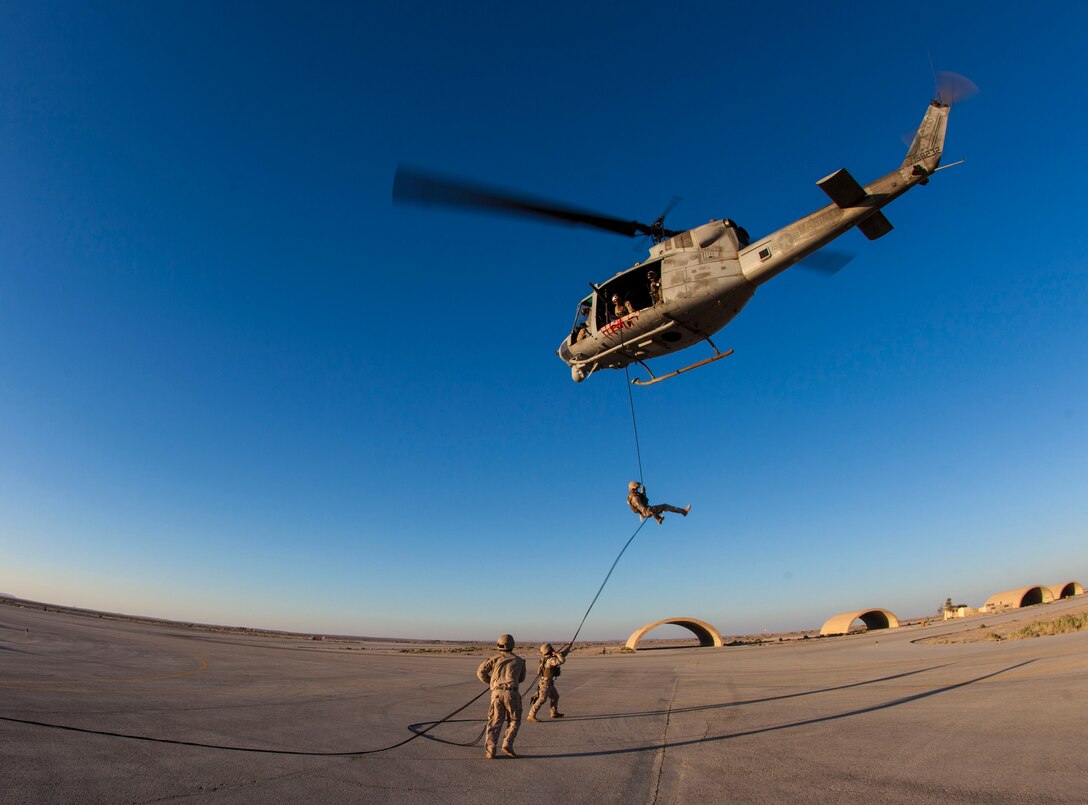 A 26th Marine Expeditionary Unit (MEU) Maritime Raid Force Marine rappels from a UH-1N Huey assigned to Marine Medium Tiltrotor Squadron (VMM) 266 (Reinforced), during a helicopter rope suspension technique exercise at King Faisal Air Base in Jordan, June 11, 2013. Exercise Eager Lion 2013 is an annual, multinational exercise designed to strengthen military-to-military relationships and enhance security and stability in the region by responding to modern-day security scenarios. The 26th MEU is a Marine Air-Ground Task Force forward-deployed to the U.S. 5th Fleet area of responsibility aboard the Kearsarge Amphibious Ready Group serving as a sea-based, expeditionary crisis response force capable of conducting amphibious operations across the full range of military operations. (U.S. Marine Corps photograph by Sgt. Christopher Q. Stone, 26th MEU Combat Camera/Released)