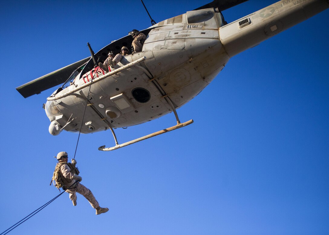 A 26th Marine Expeditionary Unit (MEU) Maritime Raid Force Marine rappels from a UH-1N Huey assigned to Marine Medium Tiltrotor Squadron (VMM) 266 (Reinforced), during a helicopter rope suspension technique exercise at King Faisal Air Base in Jordan, June 11, 2013. Exercise Eager Lion 2013 is an annual, multinational exercise designed to strengthen military-to-military relationships and enhance security and stability in the region by responding to modern-day security scenarios. The 26th MEU is a Marine Air-Ground Task Force forward-deployed to the U.S. 5th Fleet area of responsibility aboard the Kearsarge Amphibious Ready Group serving as a sea-based, expeditionary crisis response force capable of conducting amphibious operations across the full range of military operations. (U.S. Marine Corps photograph by Sgt. Christopher Q. Stone, 26th MEU Combat Camera/Released)