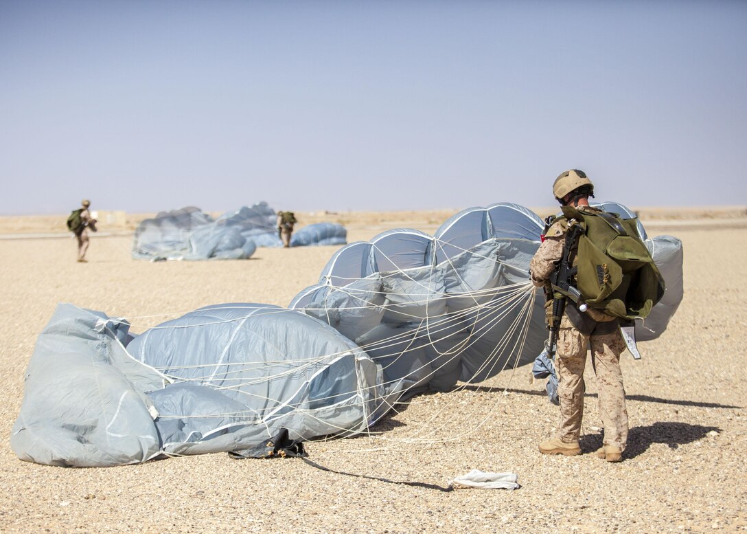 A 26th Marine Expeditionary Unit (MEU) Maritime Raid Force Marine draws in his parachute during parachute operations at King Faisal Air Base in Jordan, June 12, 2013. Exercise Eager Lion 2013 is an annual, multinational exercise designed to strengthen military-to-military relationships and enhance security and stability in the region by responding to modern-day security scenarios. The 26th MEU is a Marine Air-Ground Task Force forward-deployed to the U.S. 5th Fleet area of responsibility aboard the Kearsarge Amphibious Ready Group serving as a sea-based, expeditionary crisis response force capable of conducting amphibious operations across the full range of military operations. (U.S. Marine Corps photograph by Sgt. Christopher Q. Stone, 26th MEU Combat Camera/Released)