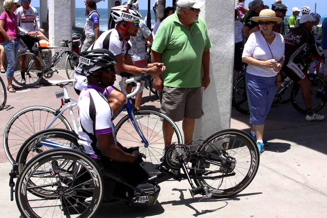 Keola Dietz and Anthony Robinson talk with spectators while they wait to be called to the Race Across America starting line at Oceanside Pier in Oceanside, Calif. June 15. Dietz and Robinson are both veterans and wounded warriors racing for the Walter Reed Bethesda Cycling team, made up of wounded Army and Marine Corps veterans who will compete in the 3,000-mile race from Oceanside, Calif. to Annapolis, Md.