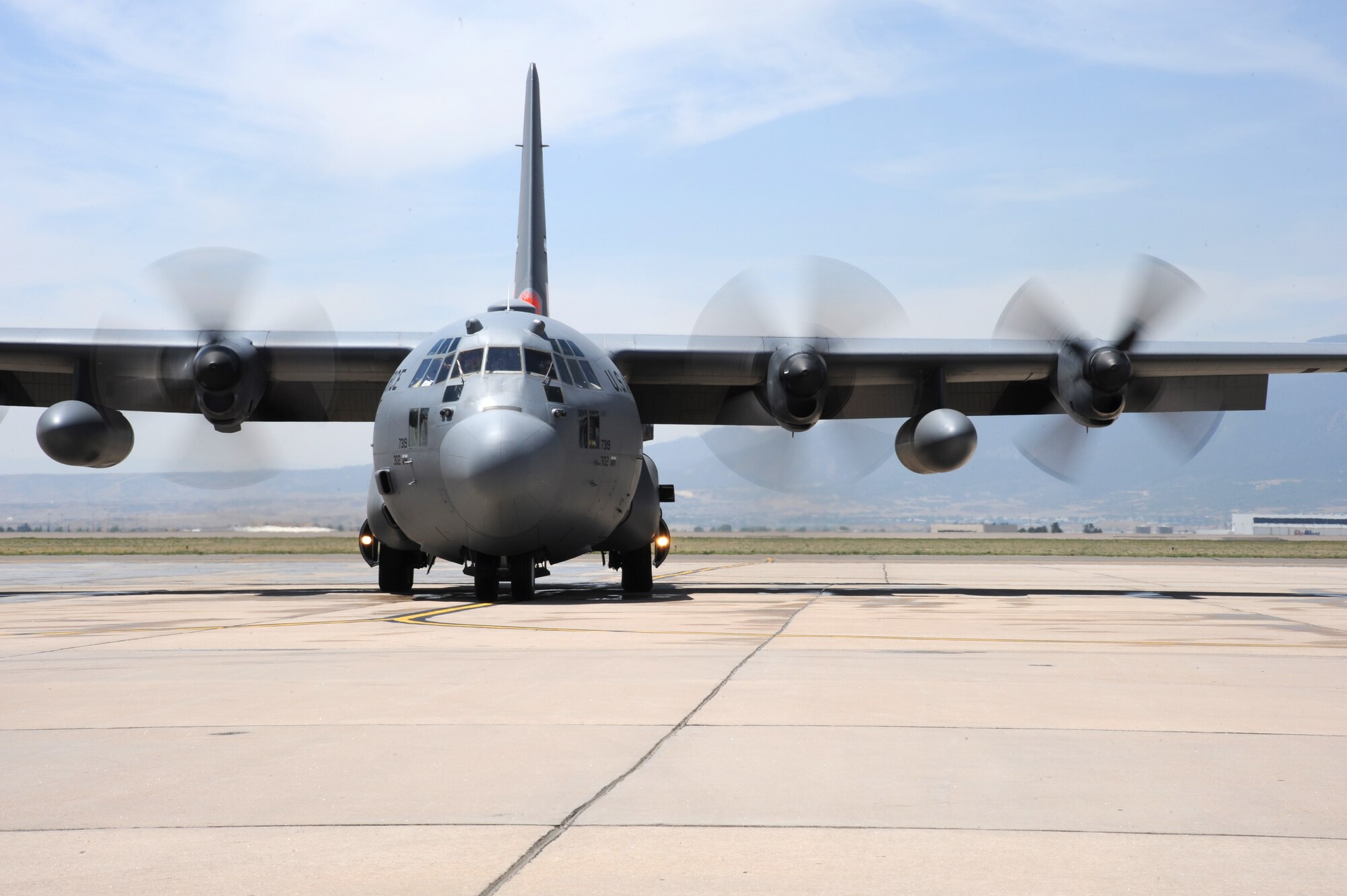 A 302nd Airlift Wing C-130, outfitted with a Modular Airborne Fire Fighting System, taxis along the Peterson Air Force Base runway preparing to assist with firefighting efforts throughout the Colorado Springs region June 12. MAFFS is designed to assist ground firefighting crews by dispersing fire retardant agents, which help mitigate and slow active fires. (U.S. Air Force photo/Staff Sgt. J. Breeden)