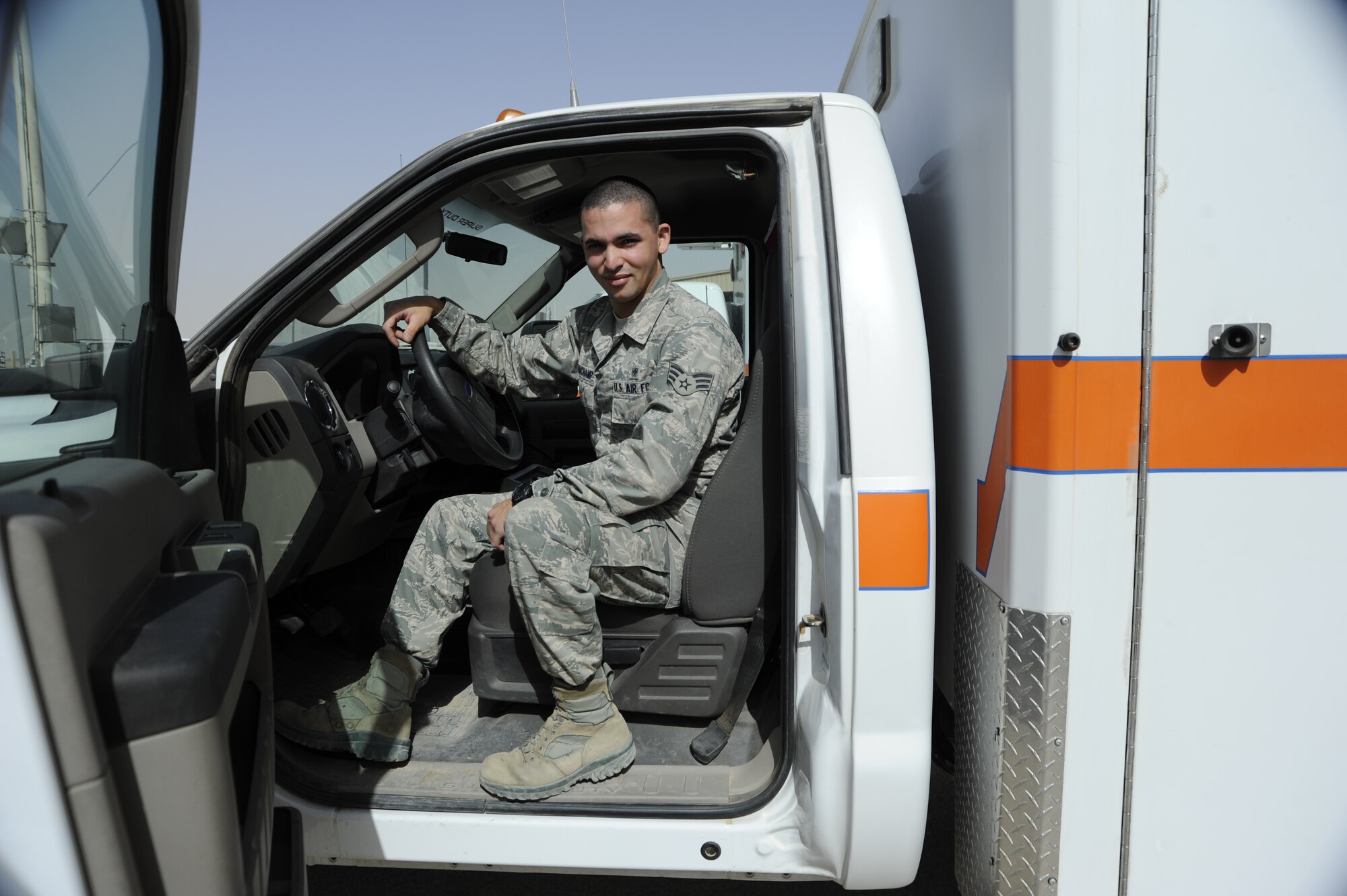 Senior Airman Daniel Beauchamp, Noncommissioned Officer In Charge of Ambulance Services sits in one of two ambulances at the 386th Air Expeditionary Wing, Southwest Asia, June 15, 2013. Beauchamp was awarded this week's "Rock Solid Warrior" designation by the 386th Top 3 Council. (U.S. Air Force photo by Master Sgt. Christopher A. Campbell)