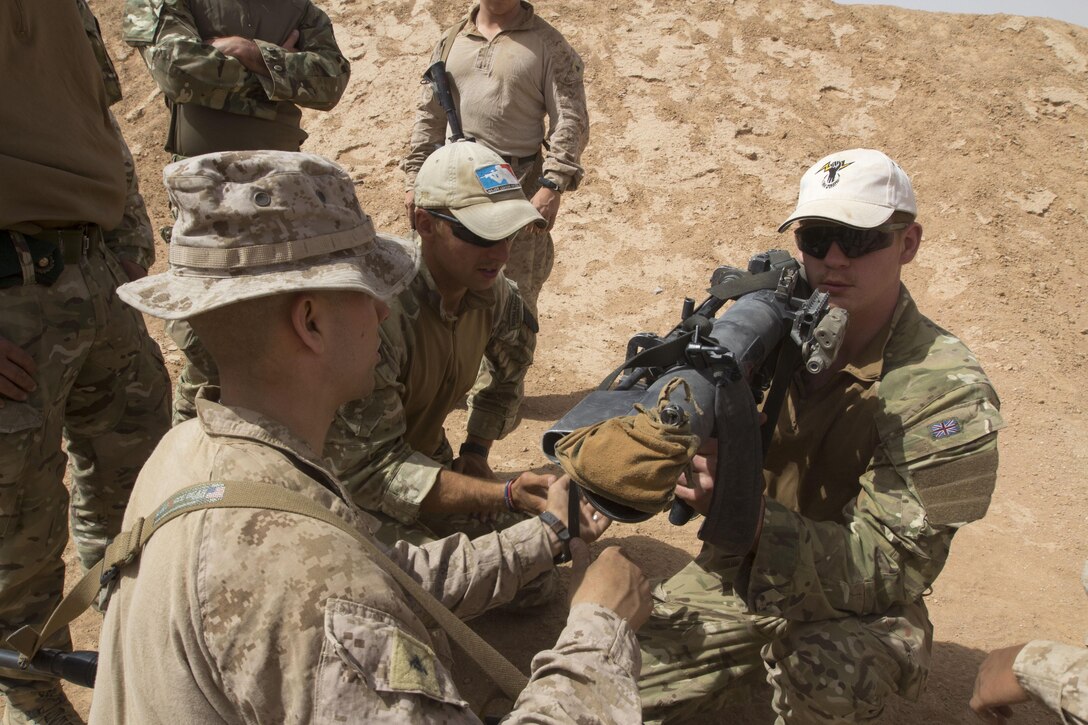 U.S. Marines assigned to Battalion Landing Team 3/2, 26th Marine Expeditionary Unit (MEU), conduct weapon familiarization on a shoulder mounted anti-armor weapon with Royal Marines assigned to 3 Commando Brigade, 42 Commando Royal Marines, in Al Humaymah, Jordan, June 9, 2013. Exercise Eager Lion 2013 is an annual multinational exercise designed to strengthen military-to-military relationships and enhance security and stability in the region by responding to modern-day security scenarios. The 26th MEU is a Marine Air-Ground Task Force forward-deployed to the U.S. 5th Fleet area of responsibility aboard the Kearsarge Amphibious Ready Group serving as a sea-based, expeditionary crisis response force capable of conducting amphibious operations across the full range of military operations. (U.S. Marine Corps photo by Cpl. Kyle N. Runnels/Released)