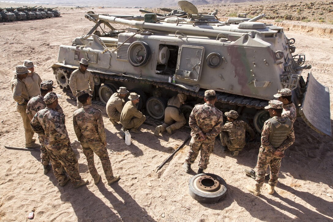 U.S. Marines and U.S. Sailors assigned to Combat Logistics Battalion 26 and Battalion Landing Team 3/2, 26th Marine Expeditionary Unit (MEU), help replace damaged track blocks of a Jordanian Armed Force's M88A1 during Exercise Eager Lion 2013 in Al Quweira, Jordan, June 13, 2013. Exercise Eager Lion 2013 is an annual multinational exercise designed to strengthen military-to-military relationships and enhance security and stability in the region. The 26th MEU is a Marine Air-Ground Task Force forward-deployed to the U.S. 5th Fleet area of responsibility aboard the Kearsarge Amphibious Ready Group serving as a sea-based, expeditionary crisis response force capable of conducting amphibious operations across the full range of military operations. (U.S. Marine Corps photo by Cpl. Kyle N. Runnels/Released)