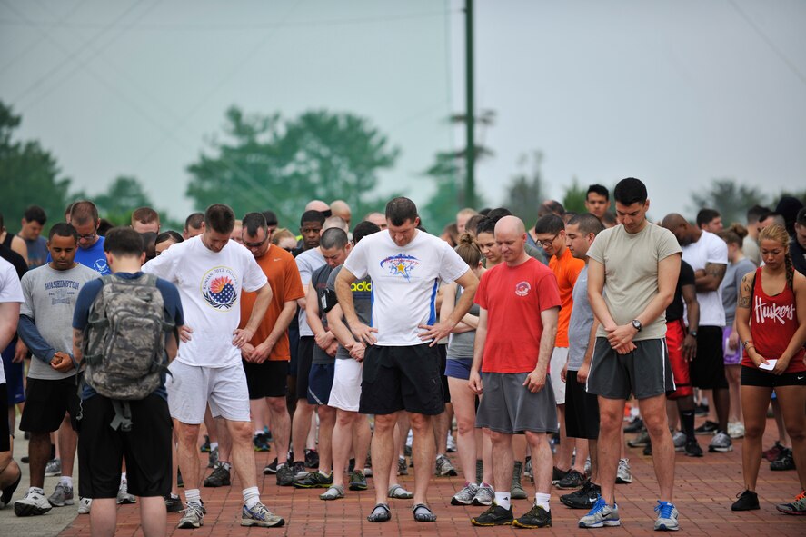 Airmen from the 8th Fighter Wing observe a moment of silence to honor 1st Lt. Josh Hovies at Kunsan Air Base, Republic of Korea, June 8, 2013. Hovies, a member of the Wolf Pack Warrior Mud Run committee, passed away in April 2013. (U.S. Air Force photo by Senior Airman Clayton Lenhardt/Released)