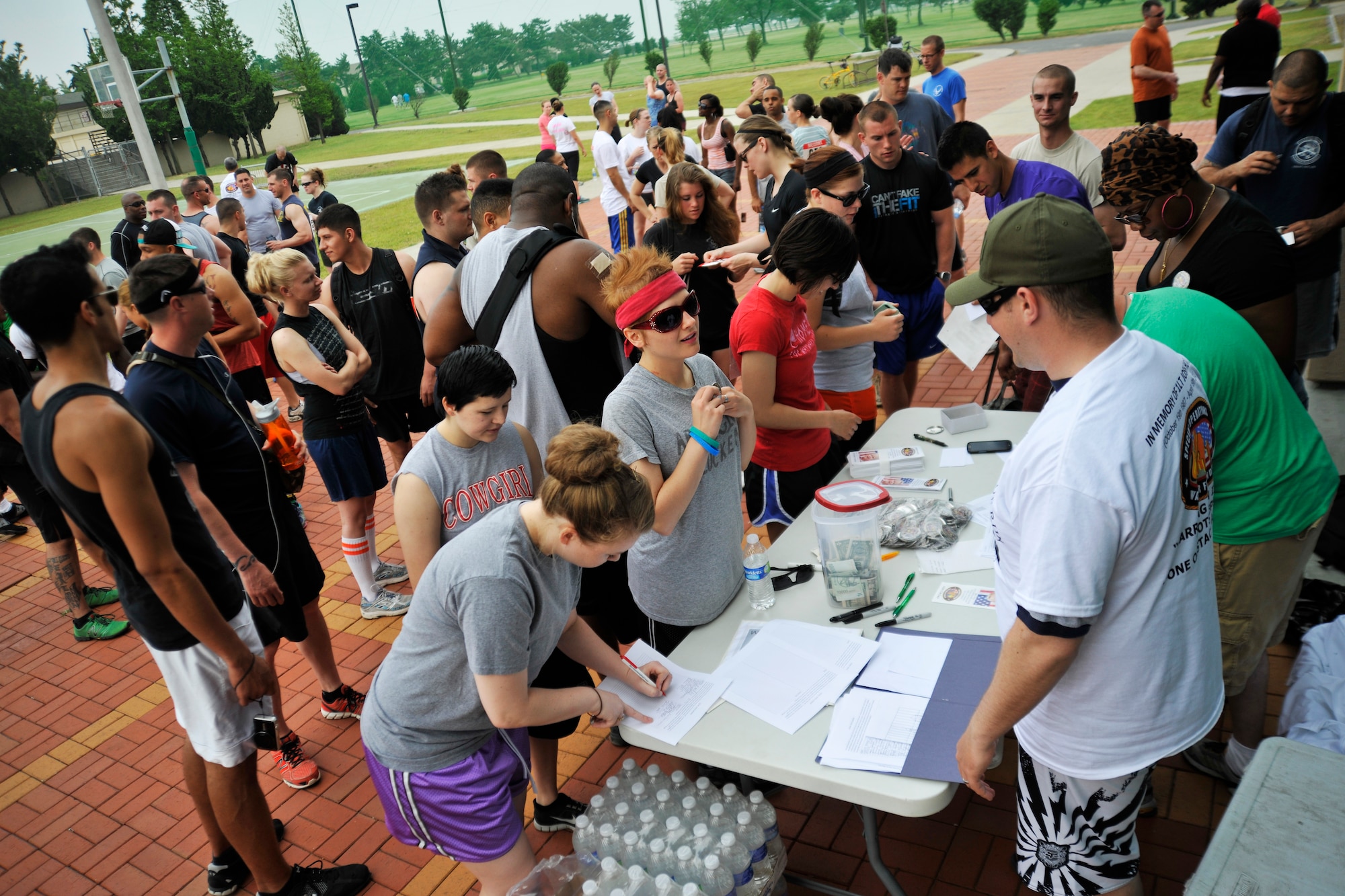 Airmen from the 8th Fighter Wing register for the Wolf Pack Warrior Mud Run at Kunsan Air Base, Republic of Korea, June 8, 2013. The event raised more than $2,600 for the Special Operations Warrior Foundation, which supports the military’s special operations forces and families through scholarships, family services and wounded special operations forces support. (U.S. Air Force photo by Senior Airman Clayton Lenhardt/Released)