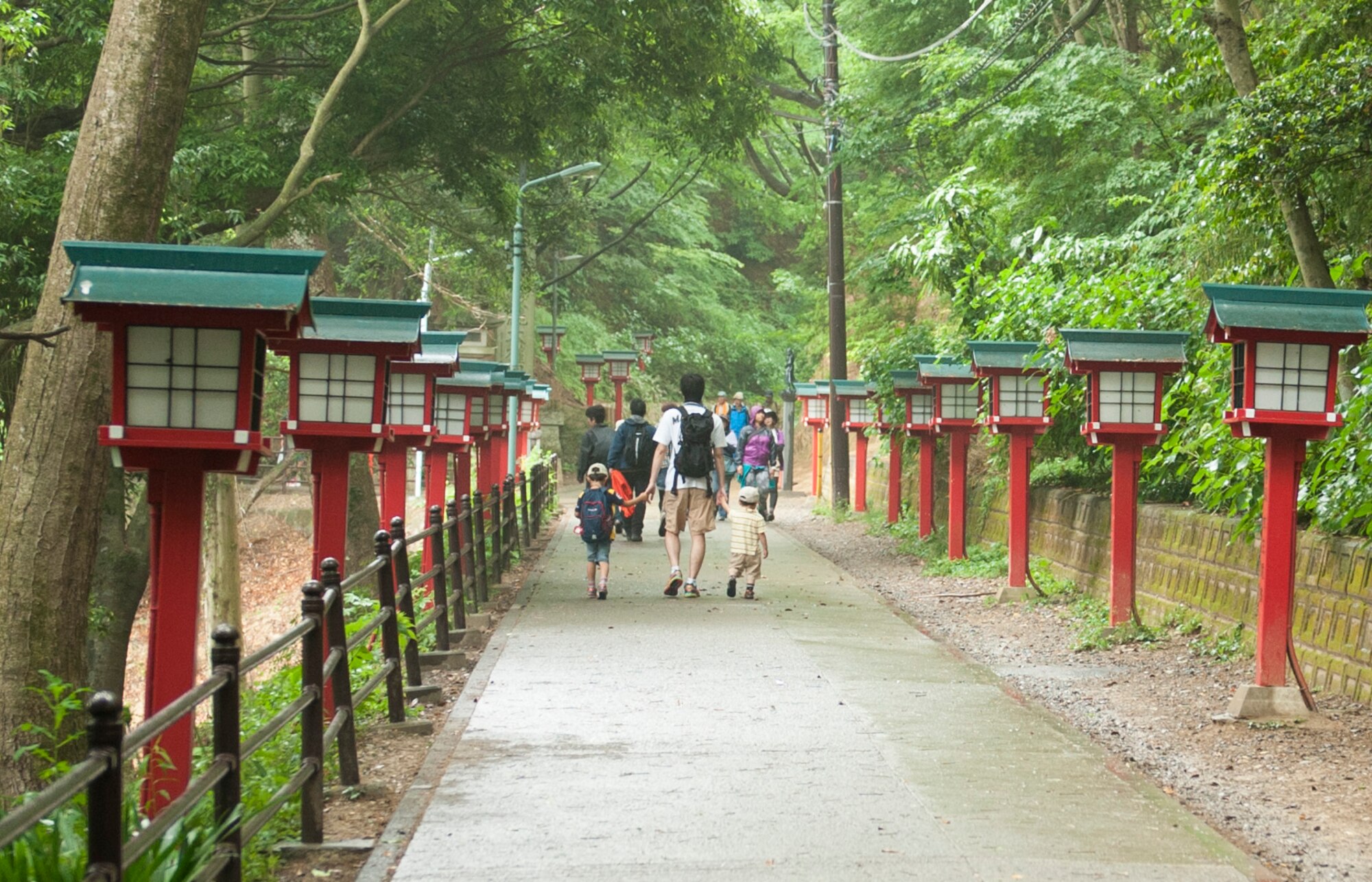 MOUNT TAKAO, Japan -- Hikers walk down a row of lights toward the entrance of Yaku-ou-in Temple on Mt. Takao June 10, 2013. About halfway up the mountain sits an observation deck where visitors can enjoy the view of the Kanto Plain. (U.S. Air Force photo by Senior Airman Michael Washburn/released)