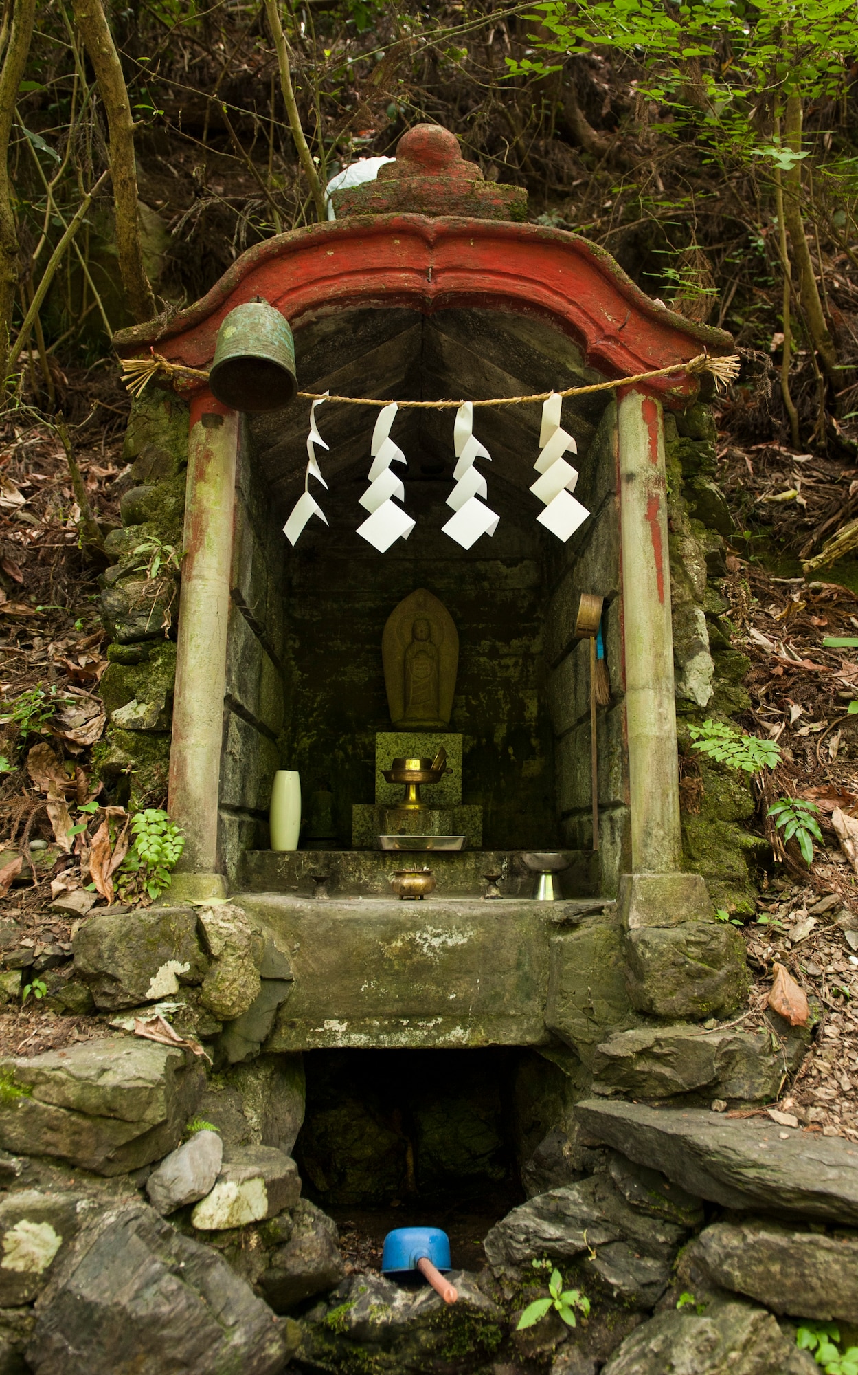 MOUNT TAKAO, Japan  -- A small shrine sits on the edge of trail number six on Mt. Takao June 10, 2013. Shrines and slabs of rock with Japanese characters inscribed on them can be found all over the mountain. (U.S. Air Force photo by Senior Airman Michael Washburn/released)