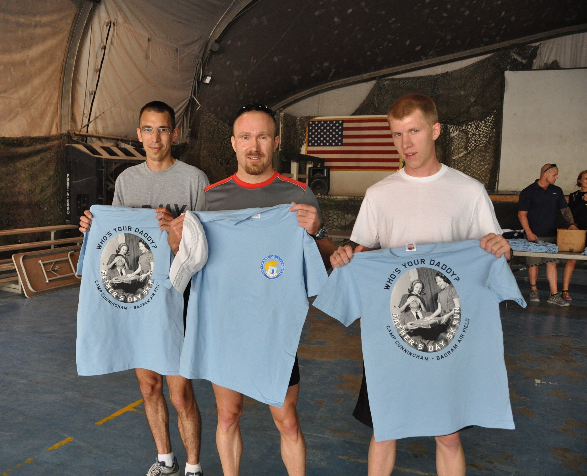 The top three runners from the annual Father’s Day 5-kilometer run held on Bagram Airfield, Afghanistan, pose with their finisher’s t-shirts June 16, 2013. More than 600 runners participated in the annual event, which was hosted by the morale, welfare and recreation office and run in honor of deployed fathers. (U.S. Air Force photo/Tech. Sgt. Rob Hazelett)