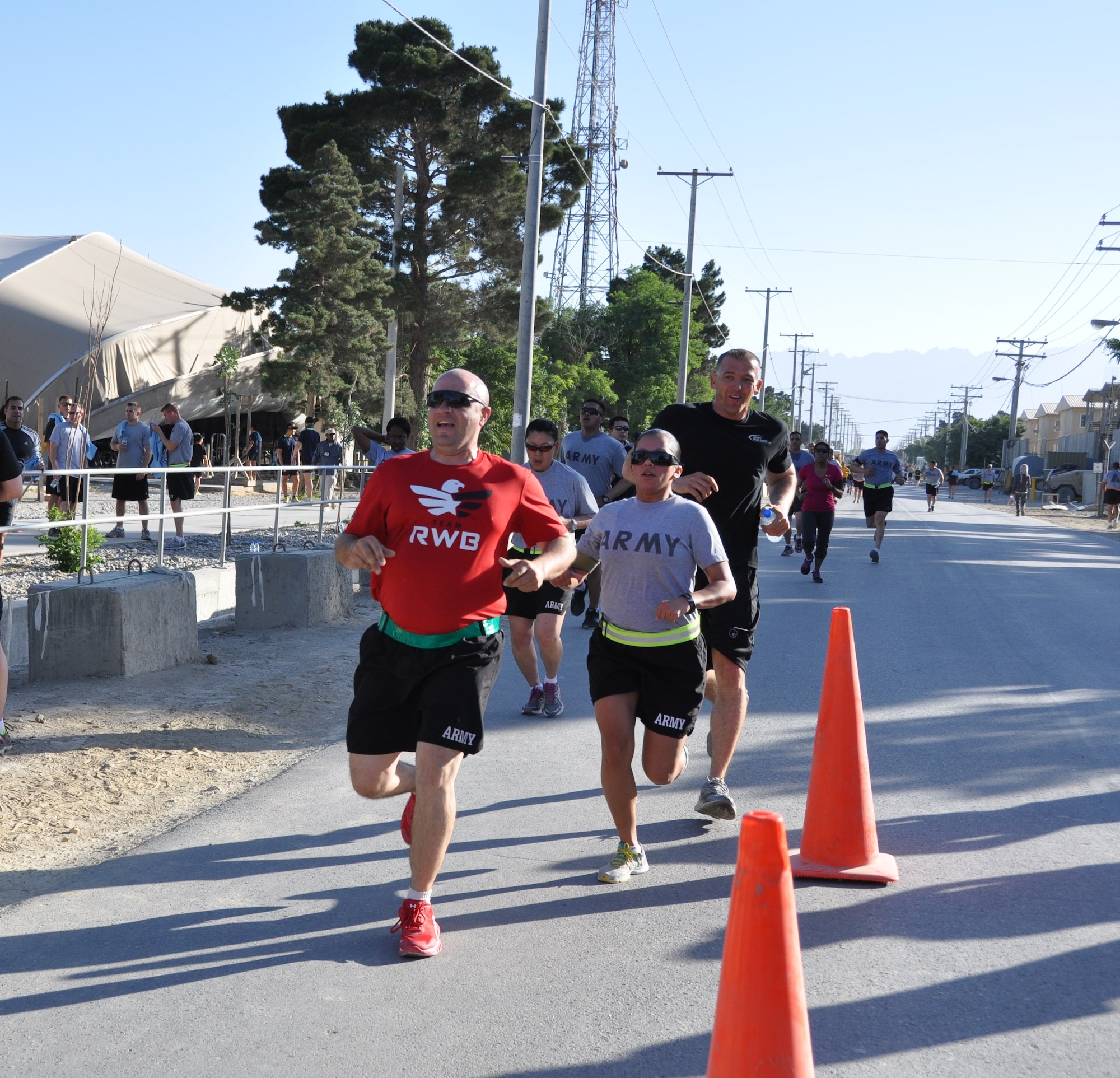 A group of runners cross the finish line during the annual Father’s Day 5-kilometer run hosted by the morale, welfare and recreation office on Bagram Airfield, Afghanistan, June 16, 2013. More than 600 runners participated in the event, which was run in honor of deployed fathers. (U.S. Air Force photo/Tech. Sgt. Rob Hazelett)