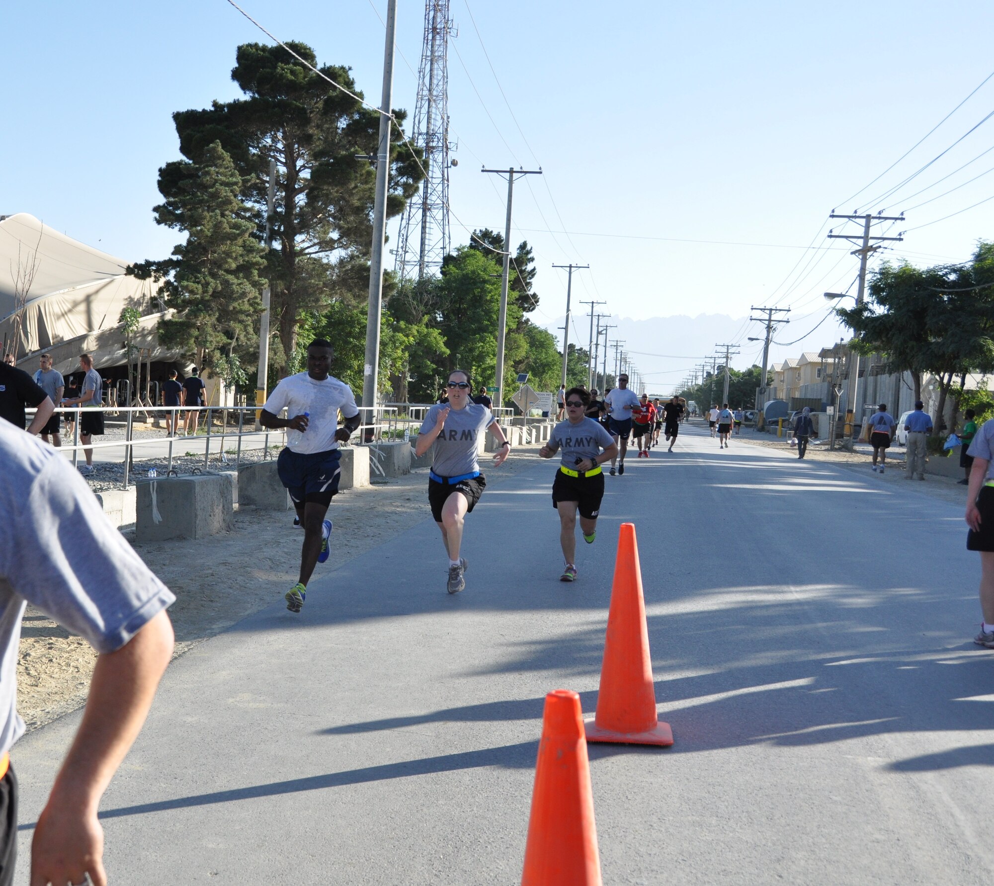 A group of runners cross the finish line during the annual Father’s Day 5-kilometer run hosted by the morale, welfare and recreation office on Bagram Airfield, Afghanistan, June 16, 2013. More than 600 runners participated in the event, which was run in honor of deployed fathers. (U.S. Air Force photo/Tech. Sgt. Rob Hazelett)
