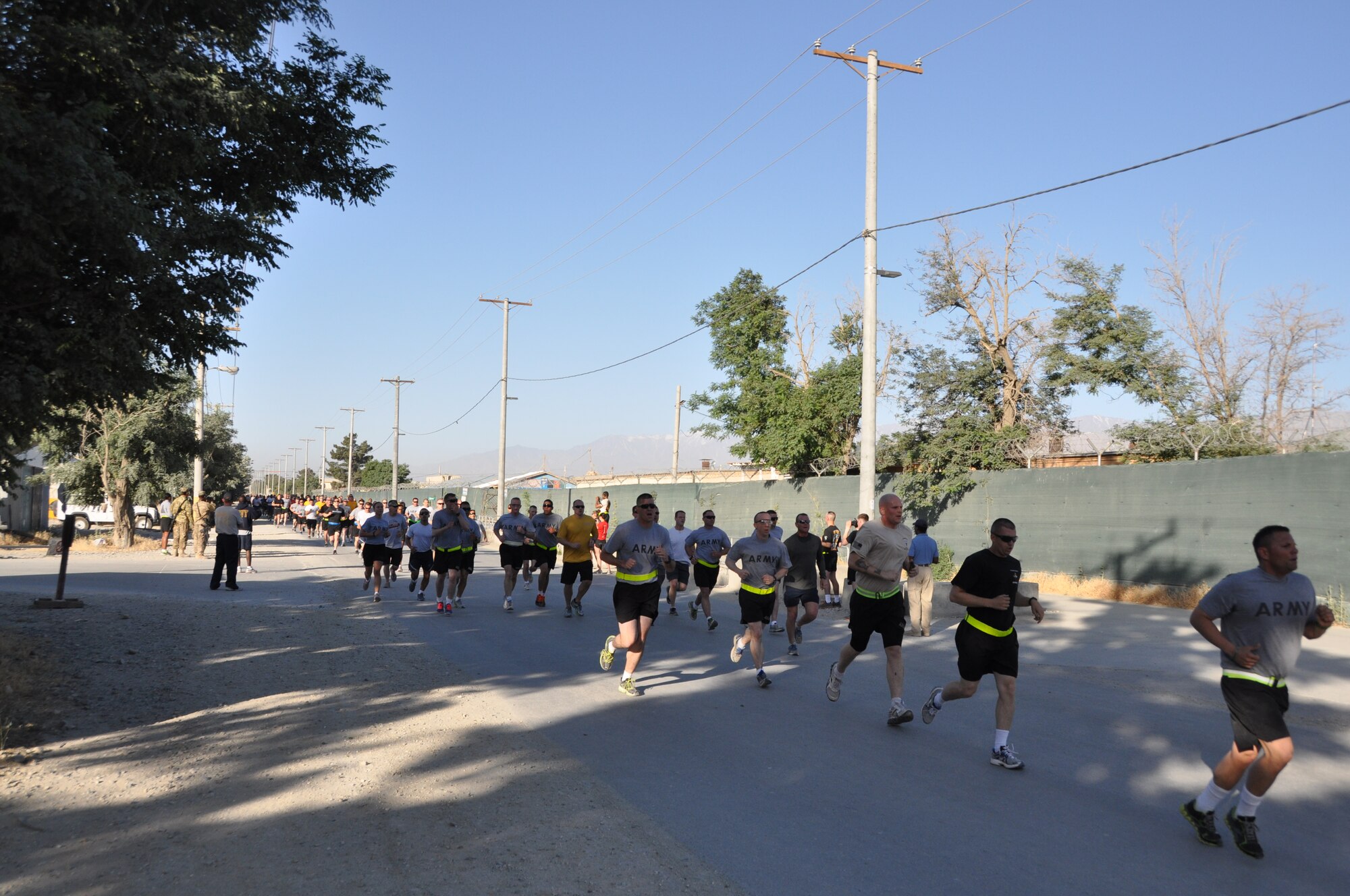 Several runners reach the mid-way point during the annual Father’s Day 5-kilometer run hosted by the morale, welfare and recreation office on Bagram Airfield, Afghanistan, June 16, 2013. More than 600 runners participated in the event, which was run in honor of deployed fathers. (U.S. Air Force photo/Tech. Sgt. Rob Hazelett)