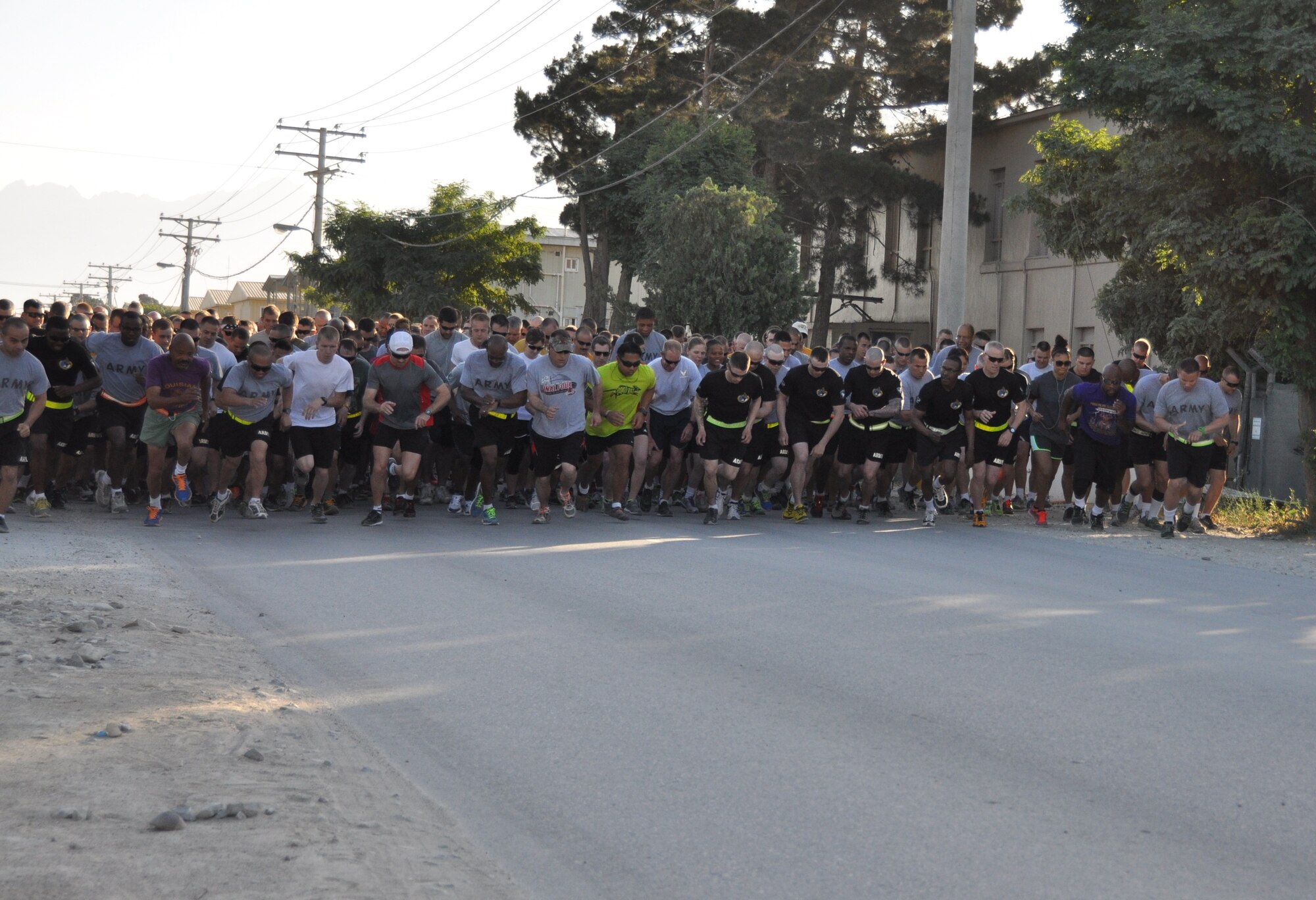 More than 600 runners cross the start line during a Father’s Day 5-kilometer run held on Bagram Airfield, Afghanistan June 16. The annual event, which was hosted by the morale, welfare and recreation office was run in honor of deployed fathers. (U.S. Air Force photo/Tech. Sgt. Rob Hazelett)