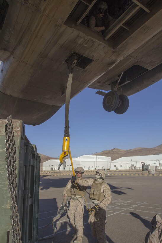 A helicopter suspension team assigned to landing support detachment, Combat Logistics Battalion 26, 26th Marine Expeditionary Unit (MEU), prepares to attach a quadcon to a CH-53E Super Stallion assigned to Marine Medium Tiltrotor Squadron (VMM) 266 (Reinforced), 26th MEU, during Exercise Eager Lion 2013 in Al Quweira, Jordan, June 13, 2013. Exercise Eager Lion 2013 is an annual multinational exercise designed to strengthen military-to-military relationships and enhance security and stability in the region. The 26th MEU is a Marine Air-Ground Task Force forward-deployed to the U.S. 5th Fleet area of responsibility aboard the Kearsarge Amphibious Ready Group serving as a sea-based, expeditionary crisis response force capable of conducting amphibious operations across the full range of military operations. (U.S. Marine Corps photo by Cpl. Kyle N. Runnels/Released)