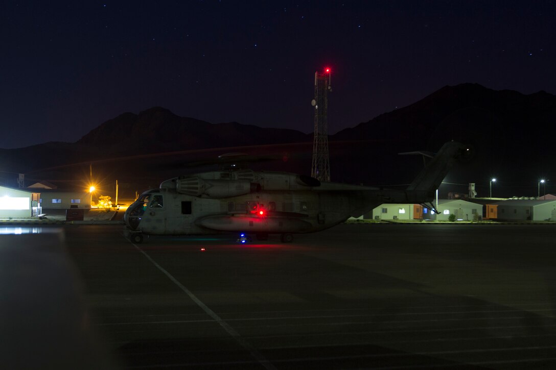 A helicopter suspension team assigned to landing support detachment, Combat Logistics Battalion 26, 26th Marine Expeditionary Unit (MEU), prepares to attach a quadcon to a CH-53E Super Stallion assigned to Marine Medium Tiltrotor Squadron (VMM) 266 (Reinforced), 26th MEU, during Exercise Eager Lion 2013 in Al Quweira, Jordan, June 13, 2013. Exercise Eager Lion 2013 is an annual multinational exercise designed to strengthen military-to-military relationships and enhance security and stability in the region. The 26th MEU is a Marine Air-Ground Task Force forward-deployed to the U.S. 5th Fleet area of responsibility aboard the Kearsarge Amphibious Ready Group serving as a sea-based, expeditionary crisis response force capable of conducting amphibious operations across the full range of military operations. (U.S. Marine Corps photo by Cpl. Kyle N. Runnels/Released)