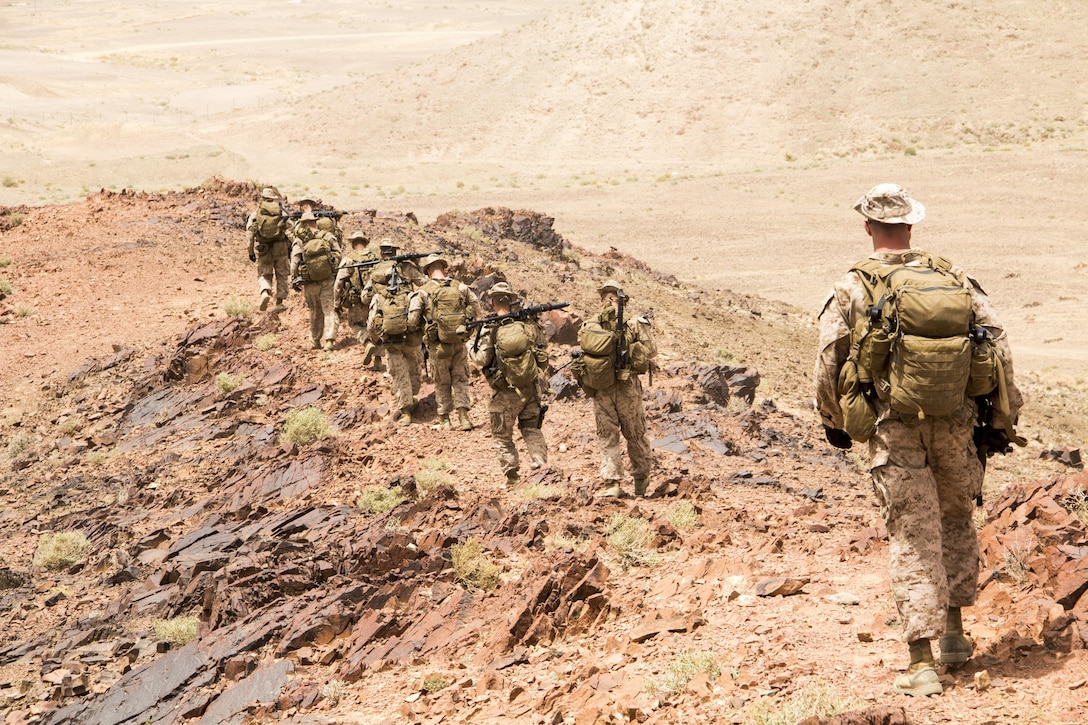 U.S. Marines assigned to Lima Company, Battalion Landing Team 3/2, 26th Marine Expeditionary Unit (MEU), hike back to base camp while training in Al Quweira, Jordan, during Exercise Eager Lion 13, June 9, 2013. Exercise Eager Lion 2013 is an annual, multinational exercise designed to strengthen military-to-military relationships and enhance security and stability in the region by responding to realistic, modern-day security scenarios. The 26th MEU is a Marine Air-Ground Task Force forward-deployed to the U.S. 5th Fleet area of responsibility aboard the Kearsarge Amphibious Ready Group serving as a sea-based, expeditionary crisis response force capable of conducting amphibious operations across the full range of military operations. (U.S. Marine Corps photograph by Lance Cpl. Juanenrique Owings, 26th MEU Combat Camera/Released)