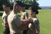 Staff Sgt. Robin R. Clements receives a Navy and Marine Corps Commendation Medal during her retirement ceremony aboard Camp Lejeune, N.C., June 14, 2013. Staff Sgt. Clements, along with her husband Gunnery Sgt. Ryan P. Clements, retired from the Marine Corps together. 