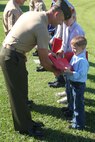 Chief Warrant Officer 3 Lawrence Jeffrey, the presiding officer and longtime family friend, presents awards to Gunnery Sgt. and Staff Sgt. Clements sons during a retirement ceremony aboard Camp Lejeune, N.C., June 14, 2013. Gunnery Sgt. and Staff Sgt. Clements both enlisted in the early 90s, serving 20 years in the Marine Corps.