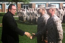 Rowdy C. Griffin, the technical director for Naval Supply Systems Command, shakes the hand of a representative of Bulk Fuel Company, 8th Engineer Support Battalion, 2nd Marine Logistics Group after presenting the American Petroleum Institute Award for excellence in fuel management aboard Camp Lejeune, N.C., June 13, 2013. Bulk fuel Company, 8th ESB has been the runner-up for the award for two consecutive years.
