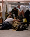 Members of the Disaster Medical Assistance Team and Air Force personnel assigned to the 6th Medical Group out of McDill Air Force Base in Tampa, Fla., comfort a patient Wednesday, Sept. 10, 2008 during a medical evacuation at Corpus Christi International Airport. U.S. Northern Command is supporting federal, state and local Hurricane Ike response efforts in Texas, and aeromedical evacuation capabilities remain on alert pending FEMA requests for assistance.