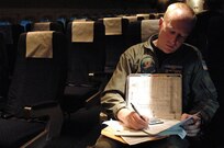 Senior Chief Ross Petersen, VR-61, Naval Air Station Whidbey Island, Washington, prepares paperwork prior to a flight carrying New Orleans evacuees at the Louis Armstrong International Airport, New Orleans, Louisiana, prior to Hurricane Gustav making land fall, Aug. 30, 2008.  