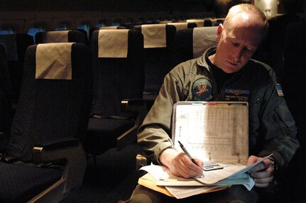 Senior Chief Ross Petersen, VR-61, Naval Air Station Whidbey Island, Washington, prepares paperwork prior to a flight carrying New Orleans evacuees at the Louis Armstrong International Airport, New Orleans, Louisiana, prior to Hurricane Gustav making land fall, Aug. 30, 2008.  