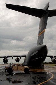 A crew based out of Altus Air Force Base, Oklahoma, prepares to load HUMVEEs, medical supplies and members of 6th Medical Group from MacDill AFB onto a C-17 Globemaster. The supplies are headed to Beaumont, Texas in preparation for hurricane Gustav relief efforts.