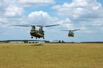 Two CH-47F Chinook helicopters from the 2nd “Lobo” Battalion, 227th Aviation Regiment, 1st Air Cavalry “Warrior” Brigade, 1st Cavalry Division, hover in a holding pattern at Hood Army Air Field, Fort Hood, Texas, July 10. Two similar Chinooks recently deployed in support of U.S. Northern Command, which is supporting federal, state and local response efforts in Texas.