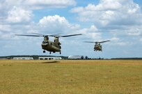 Two CH-47F Chinook helicopters from the 2nd “Lobo” Battalion, 227th Aviation Regiment, 1st Air Cavalry “Warrior” Brigade, 1st Cavalry Division, hover in a holding pattern at Hood Army Air Field, Fort Hood, Texas, July 10. Two similar Chinooks recently deployed in support of U.S. Northern Command, which is supporting federal, state and local response efforts in Texas.