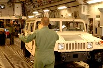 Air Force Loadmasters Master Sgt. Tom Harrison (rear) and Staff Sgt. Dustin Canterbury (Front) from Altus Air Force Base, Oklahoma, prepare to load HUMVEEs and  medical supplies onto a C-17 Globemaster. The supplies are headed to Beaumont, Texas in preparation for hurricane Gustav relief efforts.