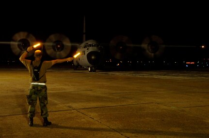 Master Sgt. Kevin Moss, Texas Air National Guard, marshals a C-130 Hercules at Southeast Texas regional airport in Beaumont, Texas. The C-130 evacuated more than 150 patients from nursing homes and extended care facilities from in and around the area in preperation for hurricane Gustav's arrival.
