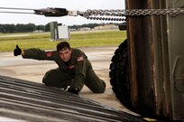 Staff Sgt. Dustin Canterbury, C-17 loadmaster from Altus Air Force Base, checks the clearance of a 10K forklift being loaded onto the aircraft. Medical supplies and vehicals were loaded up at MacDill AFB before heading to Beaumont, Texas, to assist in preparation for hurricane Gustav evacuation efforts.