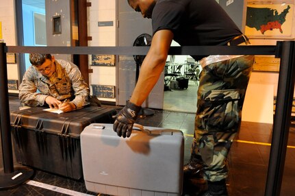 Senior Airman Robert Haog and Staff Sgt. Adam White, 573rd Global Support Squadron, 615th Contingency Response Wing, Air Mobility Command weigh luggage as evacuees of Hurricane Gustav arrive at the Louis Armstrong International Airport, New Orleans, LA., to board flights The Federal Emergency Management Agency and The Department of Defense have chartered  to transport citizens who otherwise could not leave on their own to destinations safely outside the hurricanes path, Aug. 30, 2008. 