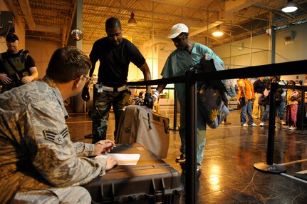 Senior Airman Robert Haog and Staff Sgt. Adam White, 573rd Global Support Squadron, 615th Contingency Response Wing, Air Mobility Command weigh luggage as evacuees of Hurricane Gustav arrive at the Louis Armstrong International Airport, New Orleans, LA., to board flights The Federal Emergency Management Agency and The Department of Defense have chartered  to transport citizens who otherwise could not leave on their own to destinations safely outside the hurricanes path, Aug. 30, 2008. 