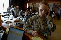 Captain Marian Collins, Logistics Officer, 615th Contingency Response Wing, Travis AFB, CA, speaks on a cell phone in the Command Center at the Luis Armstrong International Airport, New Orleans, LA, Aug. 31, 2008.   Capt Collins is supporting the operations to evacuate civilians from New Orleans prior to Hurricane Gustav making landfall.  