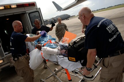 Members of the Emergency Medical Service Strike Team wheel a patient out of an ambulance prior to loading her onto a C-17 Globemaster III from McGuire Air Force Base, NJ, at the Lakefront Airport in New Orleans, LA, Aug. 31, 2008.  Members of the 199th are helping to evacuating civilian out of New Orleans prior to Hurricane Gustav making landfall.  