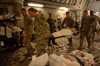 Members of the 199th Foxtrot Support Company, Lake Charles, Louisiana National Guard, move a patient aboard a C-17 Globemaster III from McGuire AFB, NJ, at the Lakefront Airport in New Orleans, LA, Aug.31, 2008.  Members of the 199th are evacuating civilian out of New Orleans prior to Hurricane Gustav making landfall.  
