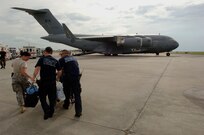 A member of the 514th Aeromedical Evacuation Squadron and two New Orleans Paramedics move a patient on a stretcher to a Canadian C-17 Globemaster III, at the Lakefront Airport in New Orleans, LA, Aug.31, 2008.  Members of the 514th are evacuating civilians out of New Orleans prior to Hurricane Gustav making landfall.  