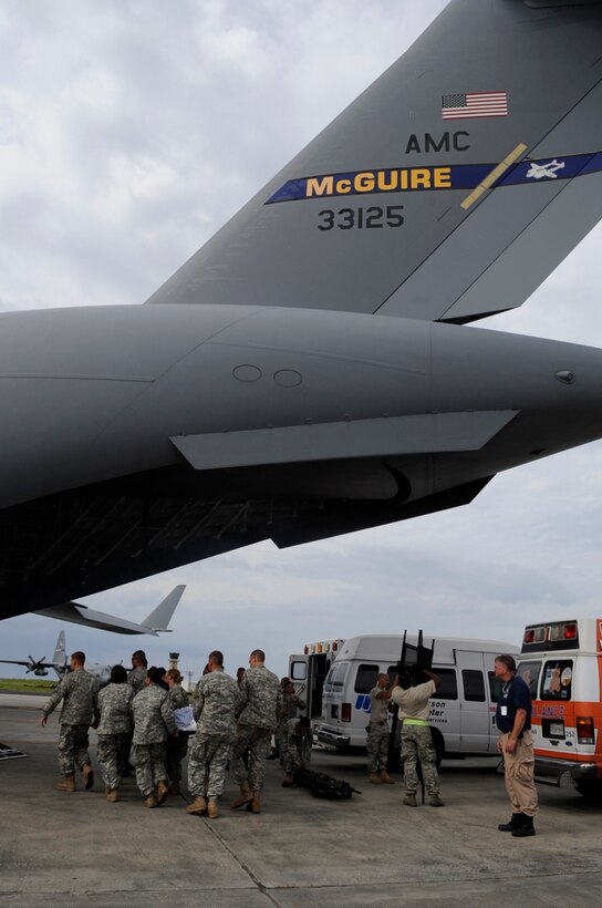 U.S. Army Soldiers and emergency personnel help an evacuee of Hurricane Gustav board a C-17 Globemaster III at Lake Front Airport, New Orleans, La., Aug. 31, 2008. The Federal Emergency Management Agency and The Department of Defense chartered flights to transport citizens to destinations safely outside the hurricanes path. 