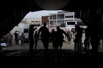 U.S. Army Soldiers and emergency personnel help an evacuee of Hurricane Gustav board a C-17 Globemaster III at Lake Front Airport, New Orleans, La., Aug. 31, 2008. The Federal Emergency Management Agency and The Department of Defense chartered flights to transport citizens to destinations safely outside the hurricanes path. 
