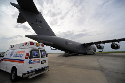 Emergency vehicles carrying evacuees of Hurricane Gustav stage near a Canadian Air Force C-17 at Lake Front Airport, New Orleans, La., Aug. 31, 2008. The Federal Emergency Management Agency and The Department of Defense chartered flights to transport citizens to destinations safely outside the hurricanes path. The Canadian Forces aircraft was brought in to help as part of the Civil Assistance Plan between the United States and Canada. 