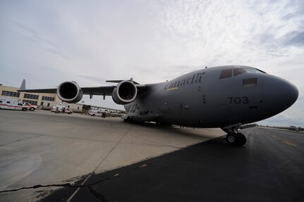 Emergency vehicles carrying evacuees of Hurricane Gustav stage near a Canadian Air Force C-17 at Lake Front Airport, New Orleans, La., Aug. 31, 2008. The Federal Emergency Management Agency and The Department of Defense chartered flights to transport citizens to destinations safely outside the hurricanes path. The Canadian Forces aircraft was brought in to help as part of the Civil Assistance Plan between the United States and Canada.